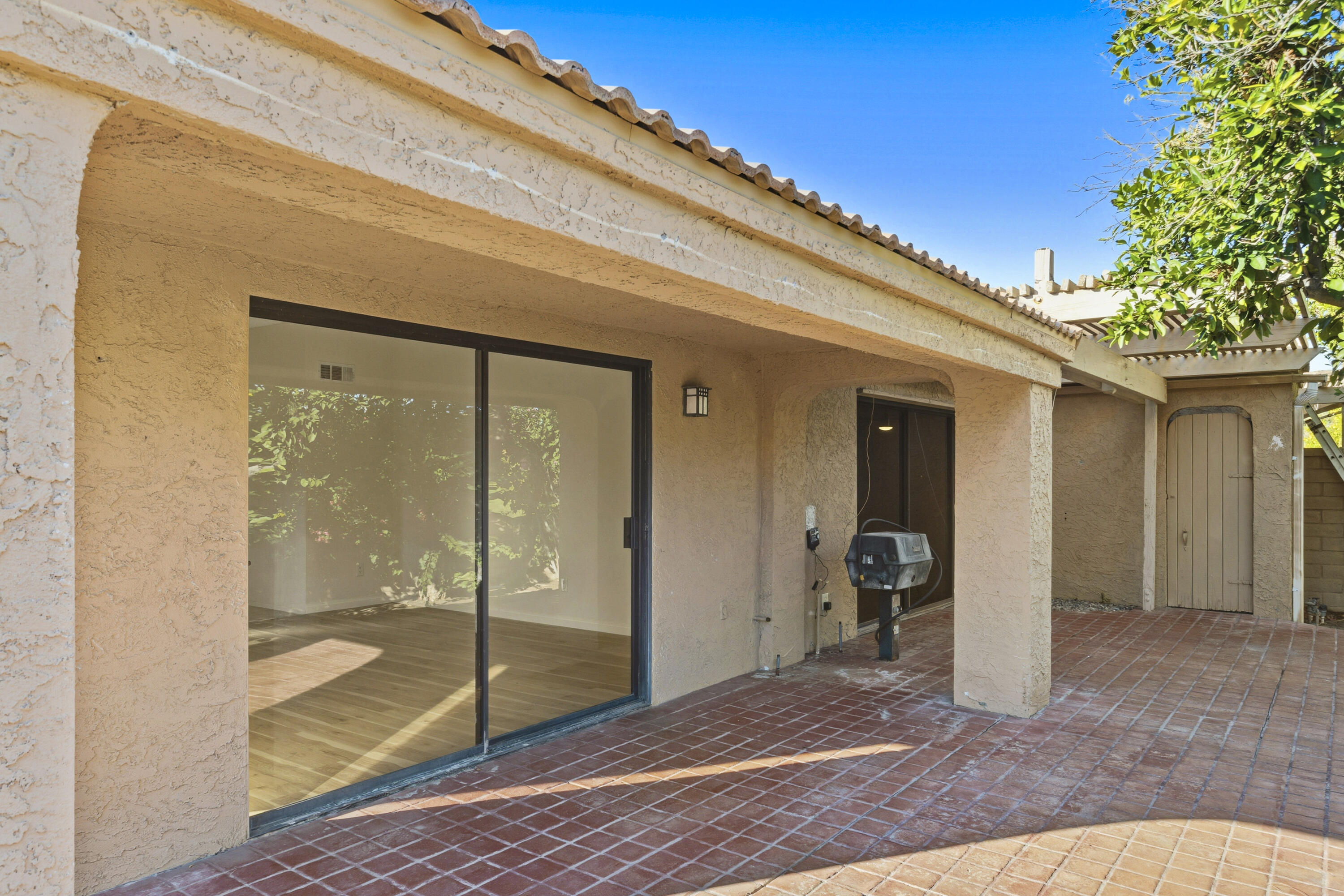 44695 Monaco Circle Palm Desert, CA 92260 - Photo 35 of 58 a view of a porch with a table and chair