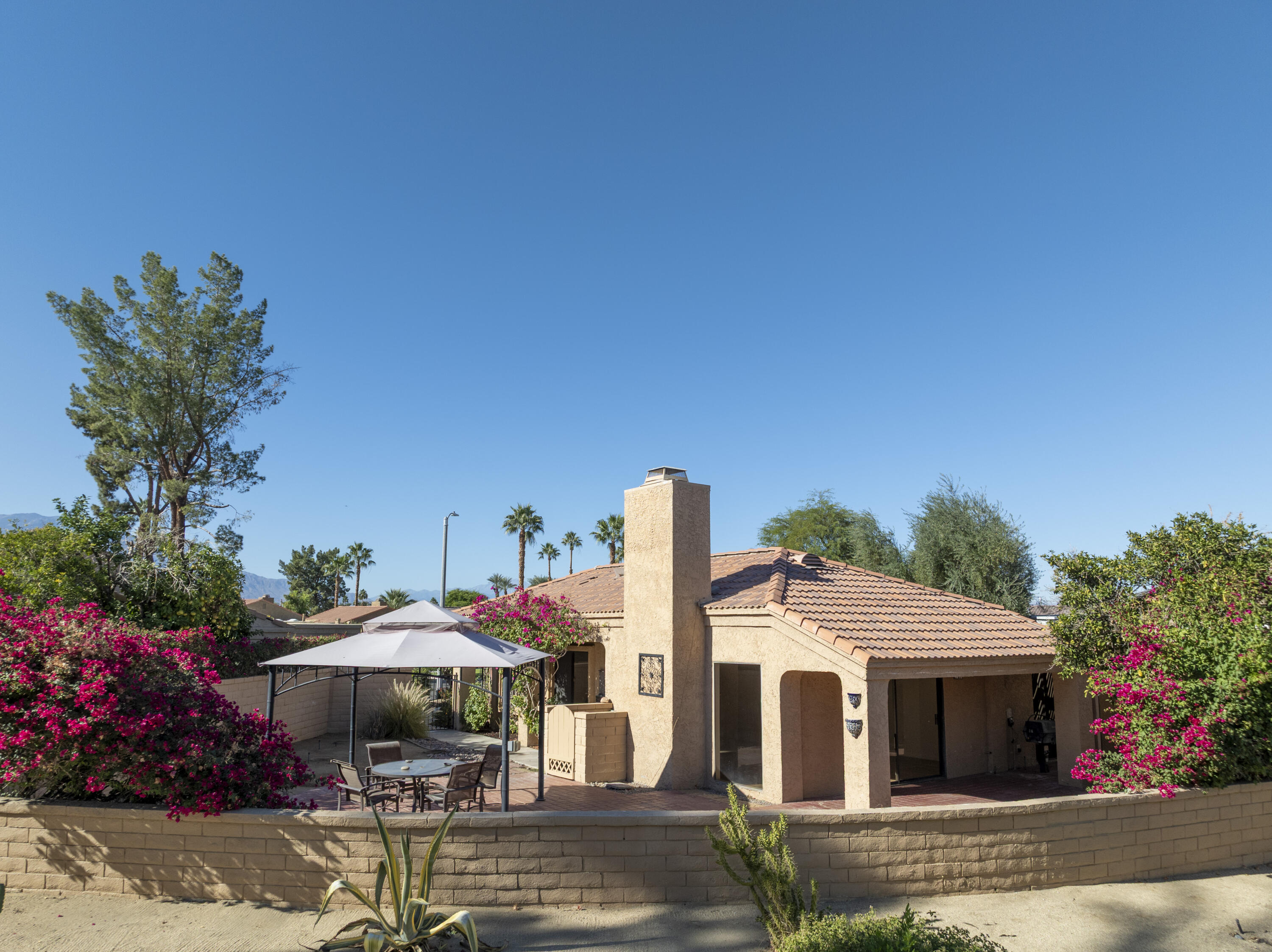 44695 Monaco Circle Palm Desert, CA 92260 - Photo 40 of 58 a front view of a house with sitting area