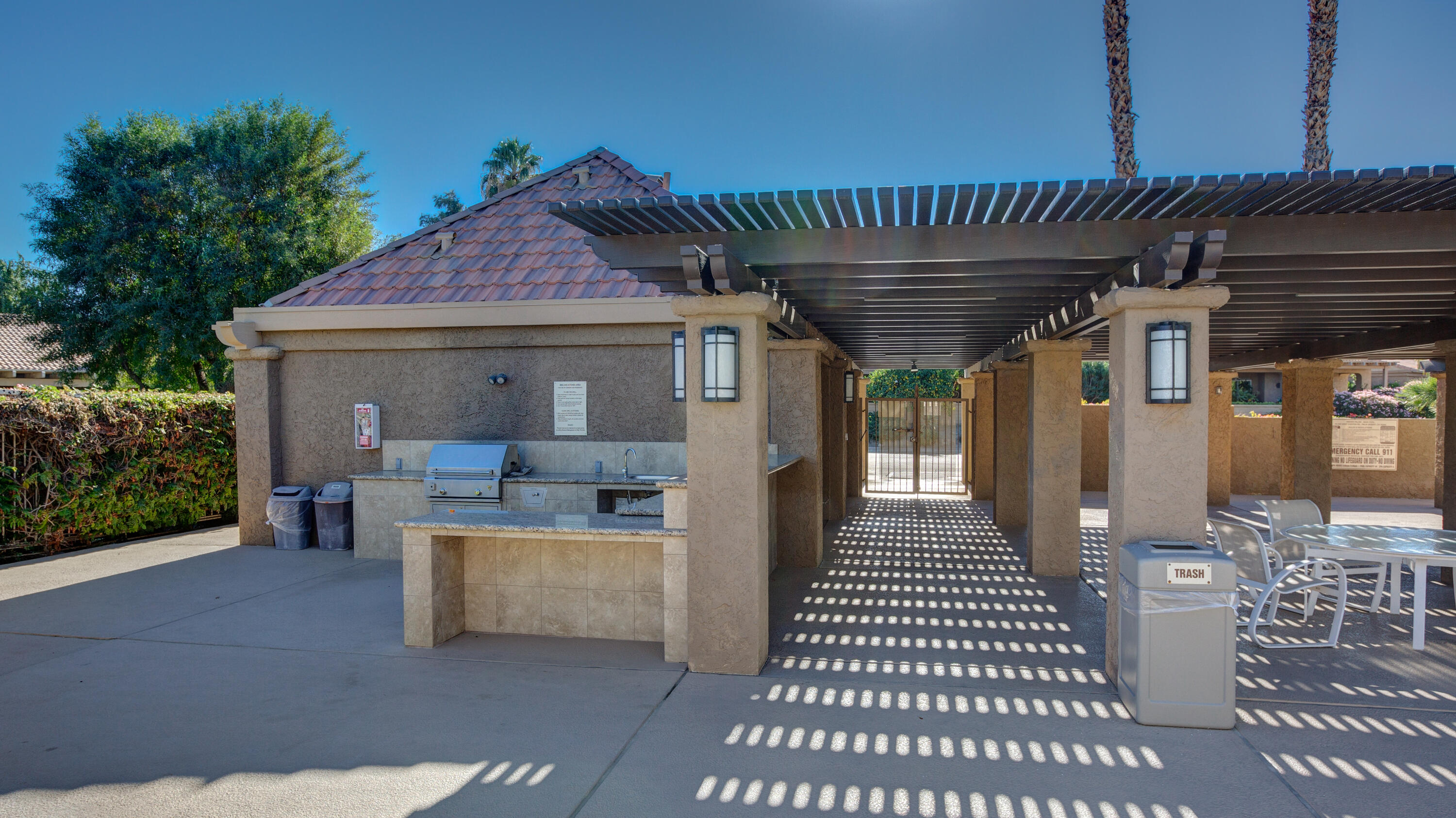44695 Monaco Circle Palm Desert, CA 92260 - Photo 41 of 58 a view of a patio with table and chairs
