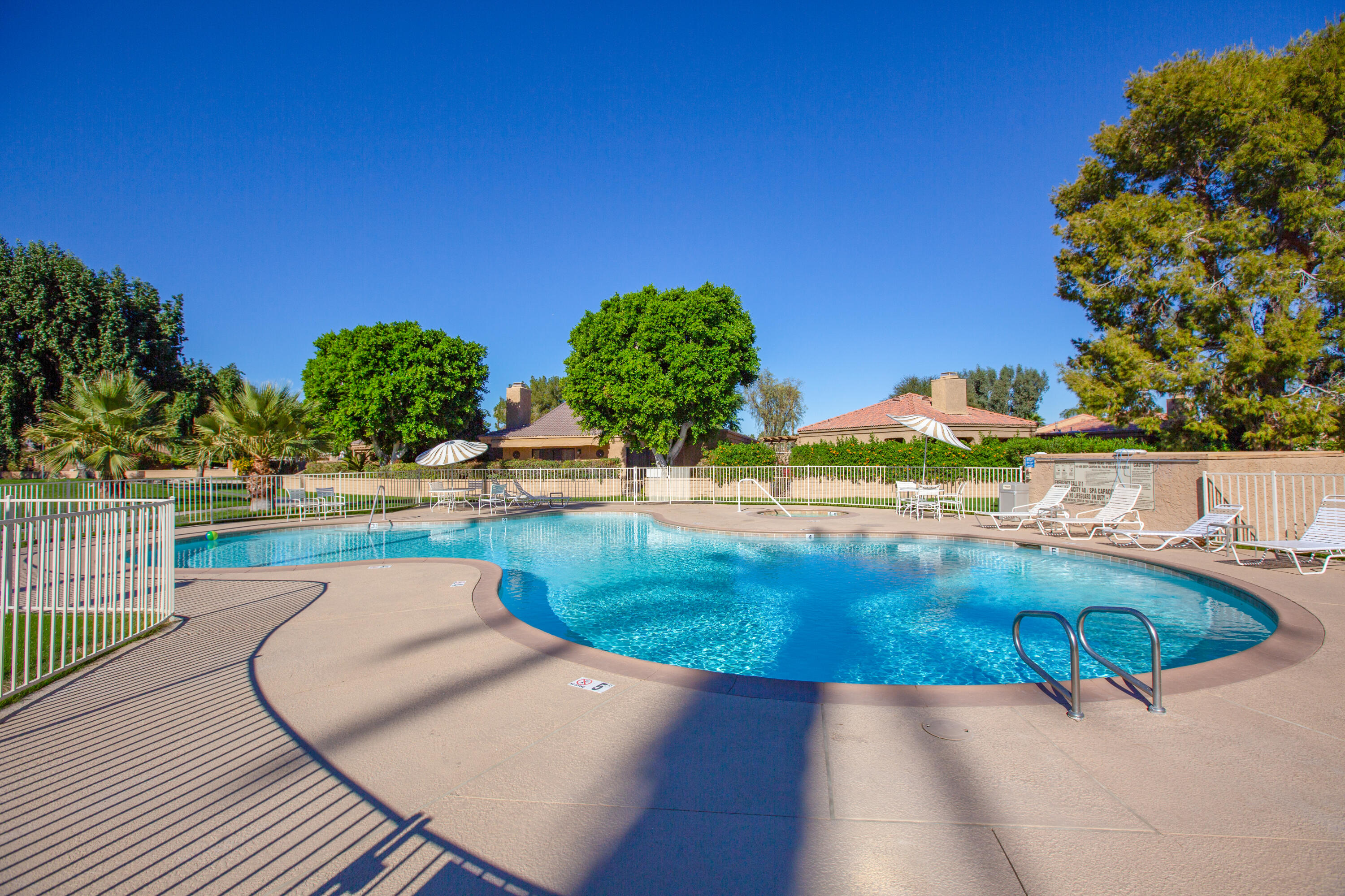 44695 Monaco Circle Palm Desert, CA 92260 - Photo 57 of 58 a view of a swimming pool with a patio