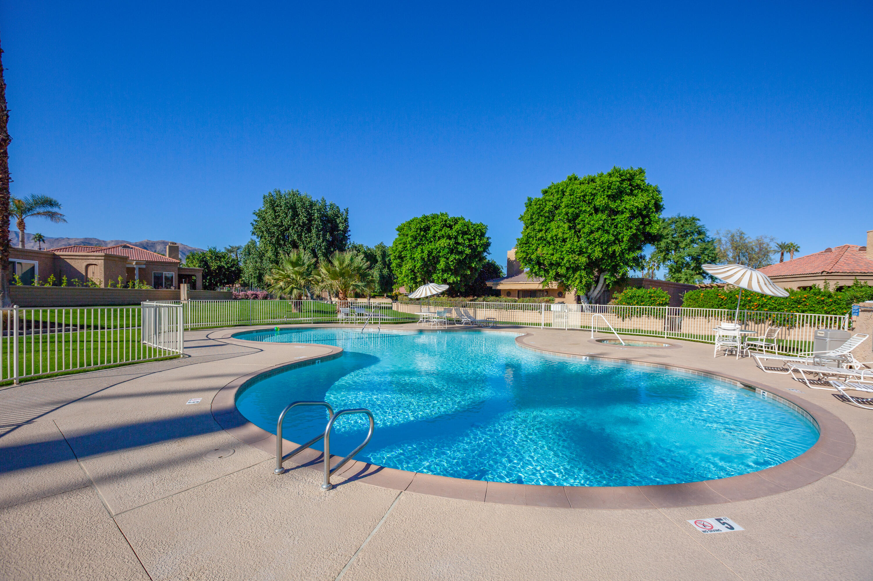 44695 Monaco Circle Palm Desert, CA 92260 - Photo 58 of 58 a view of a swimming pool with a yard