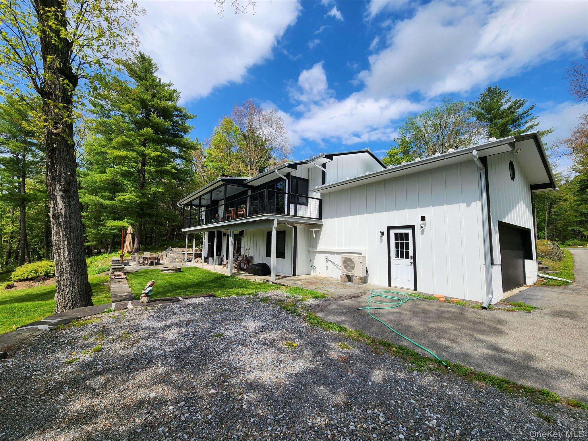 53 Lake Pleasant Road Staatsburg, NY 12580 - Photo 2 of 34 a front view of house with yard and trees in the background