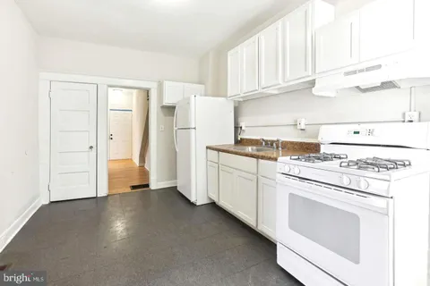 a kitchen with cabinets and white appliances