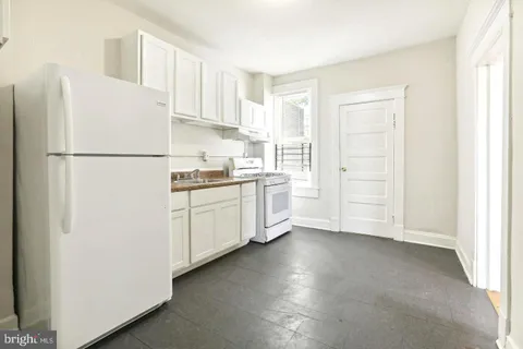 a white refrigerator freezer sitting in a kitchen