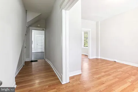 a view of a hallway with wooden floor
