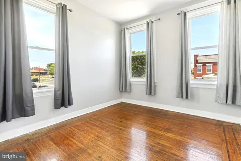 a view of a room with wooden floor and a window