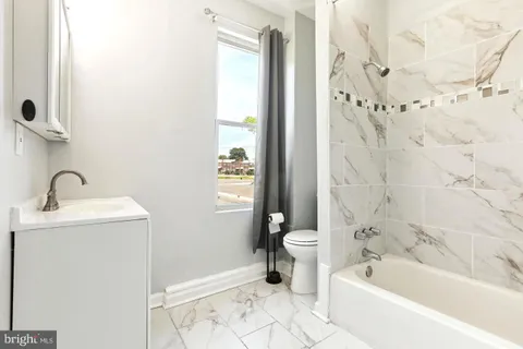 a bathroom with a sink a toilet and a bathtub