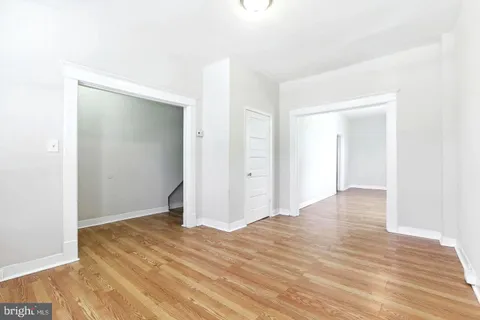 a view of a room with wooden floor