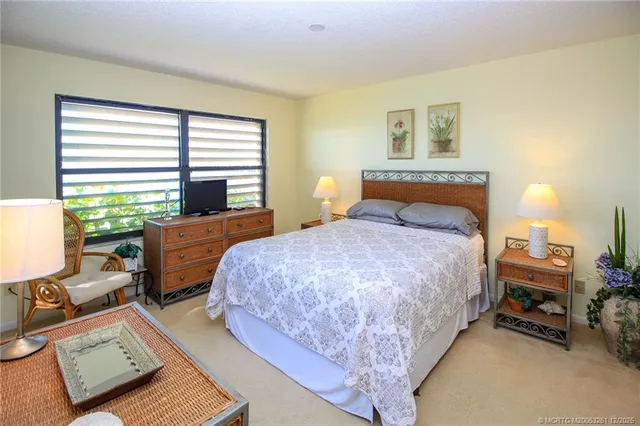 a bedroom with a bed a table and chair