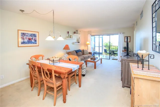 a dining room with furniture and a large window