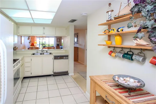 a kitchen with a sink a stove and cabinets