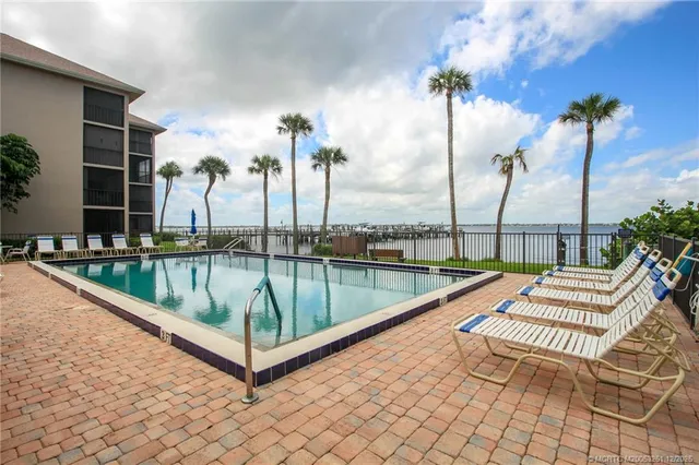 a view of swimming pool with a lounge chairs