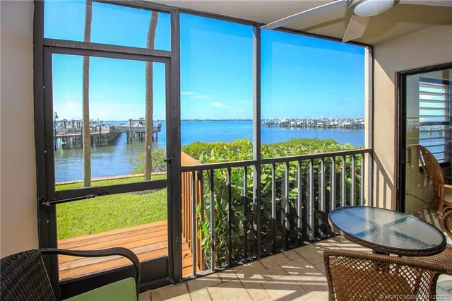 a balcony with table and chairs