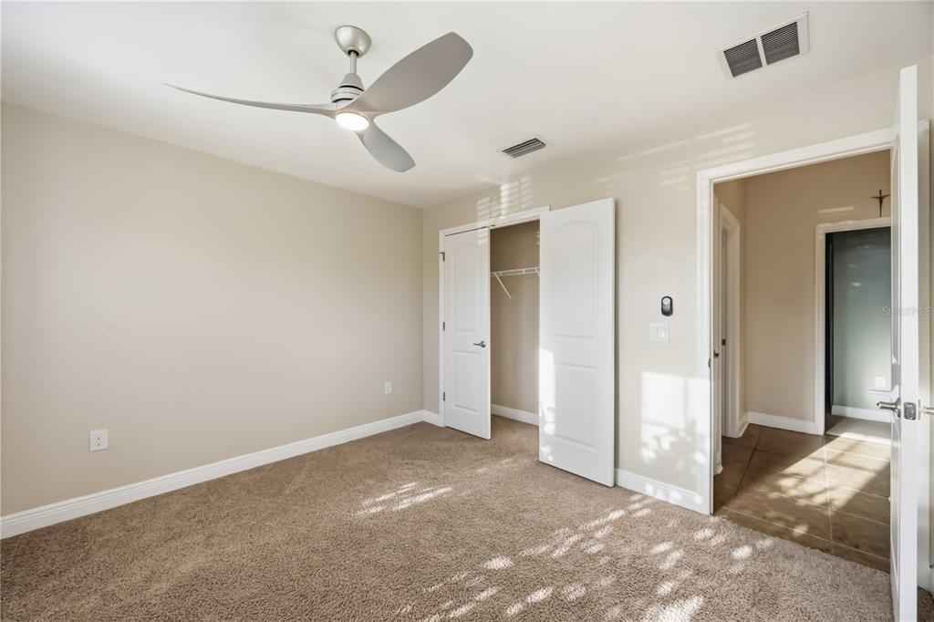 9984 Spring Gulch Lane Punta Gorda, FL 33950 - Photo 15 of 31 an empty room with fan and a ceiling fan