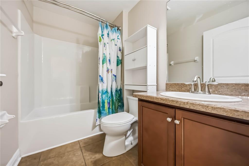 9984 Spring Gulch Lane Punta Gorda, FL 33950 - Photo 17 of 31 a bathroom with a granite countertop sink toilet and shower