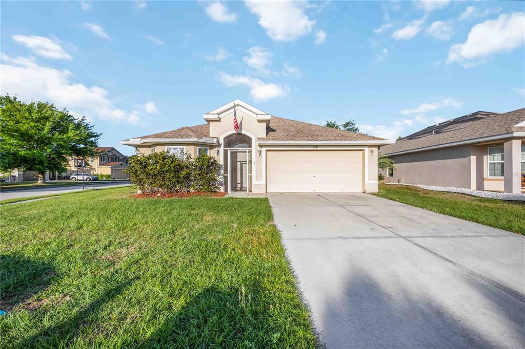 9984 Spring Gulch Lane Punta Gorda, FL 33950 - Photo 2 of 31 a front view of a house with garden