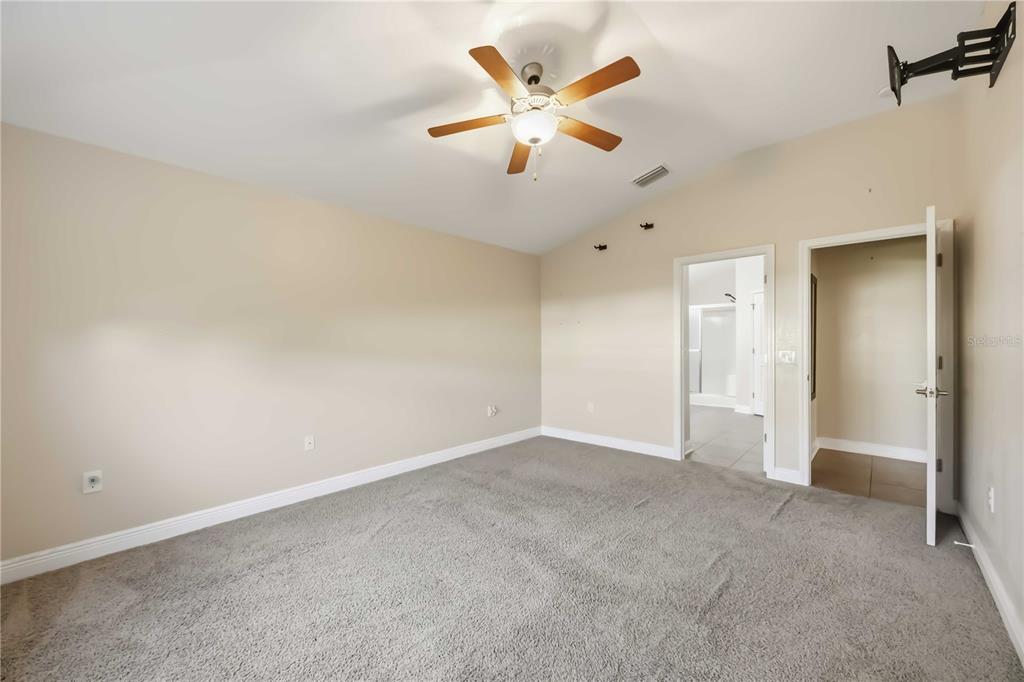 9984 Spring Gulch Lane Punta Gorda, FL 33950 - Photo 22 of 31 an empty room with closet and ceiling fan