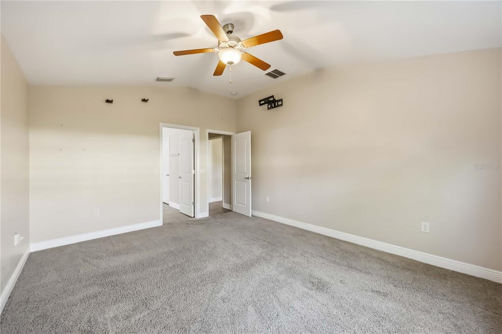 9984 Spring Gulch Lane Punta Gorda, FL 33950 - Photo 23 of 31 an empty room with chandelier fan