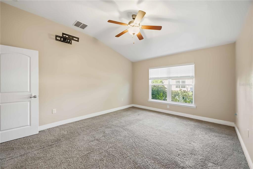 9984 Spring Gulch Lane Punta Gorda, FL 33950 - Photo 24 of 31 an empty room with windows and ceiling fan
