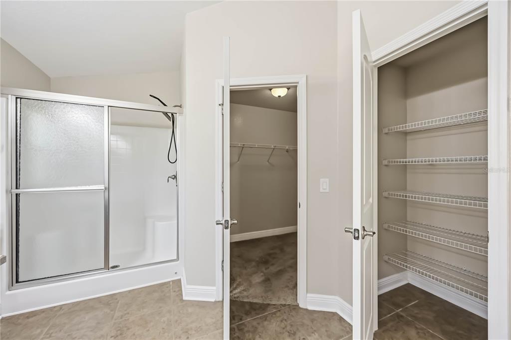 9984 Spring Gulch Lane Punta Gorda, FL 33950 - Photo 26 of 31 a bathroom with a glass shower door