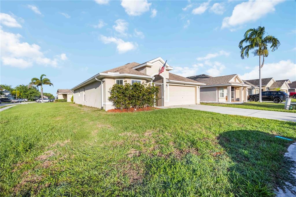 9984 Spring Gulch Lane Punta Gorda, FL 33950 - Photo 3 of 31 a front view of a house with garden