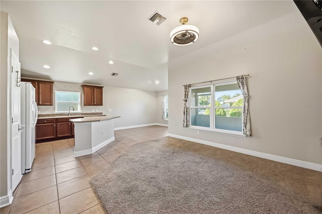 9984 Spring Gulch Lane Punta Gorda, FL 33950 - Photo 5 of 31 a large kitchen with kitchen island a sink stainless steel appliances and cabinets