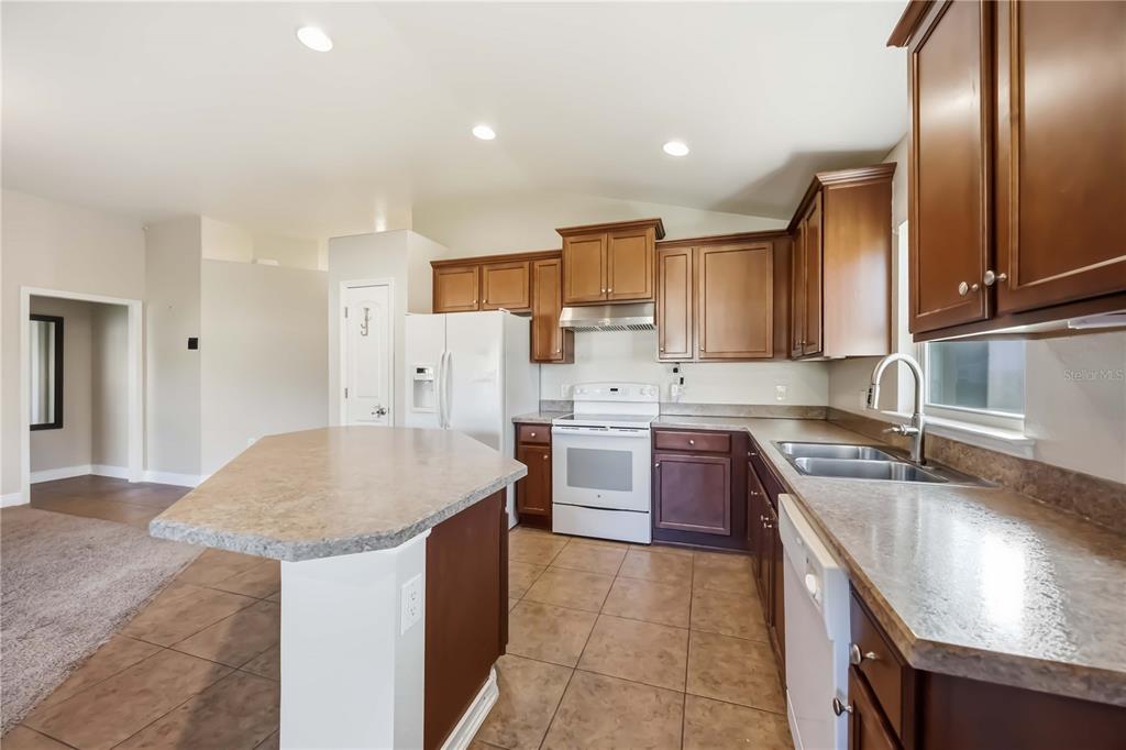 9984 Spring Gulch Lane Punta Gorda, FL 33950 - Photo 8 of 31 a kitchen with stainless steel appliances granite countertop a sink stove and refrigerator