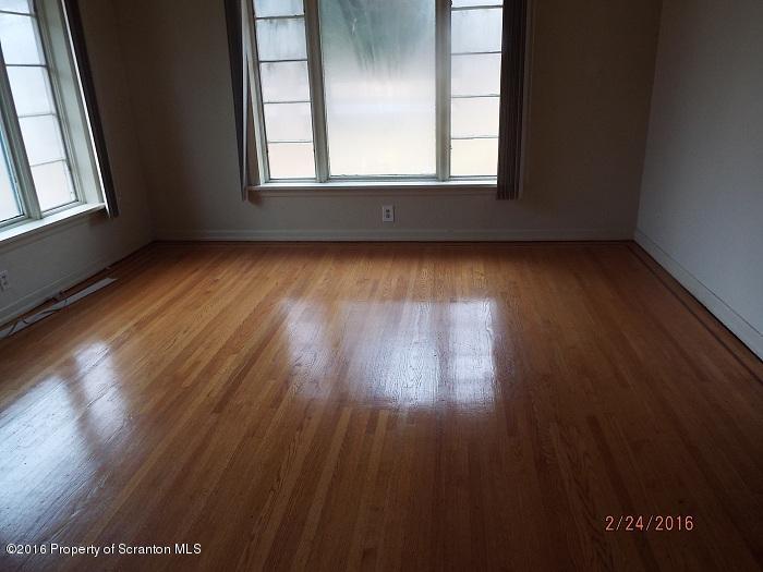 507 O'Hara Road Moscow, PA 18444 - Photo 5 of 13 an empty room with wooden floor and windows