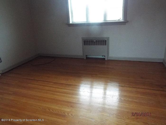 507 O'Hara Road Moscow, PA 18444 - Photo 9 of 13 an empty room with wooden floor and windows