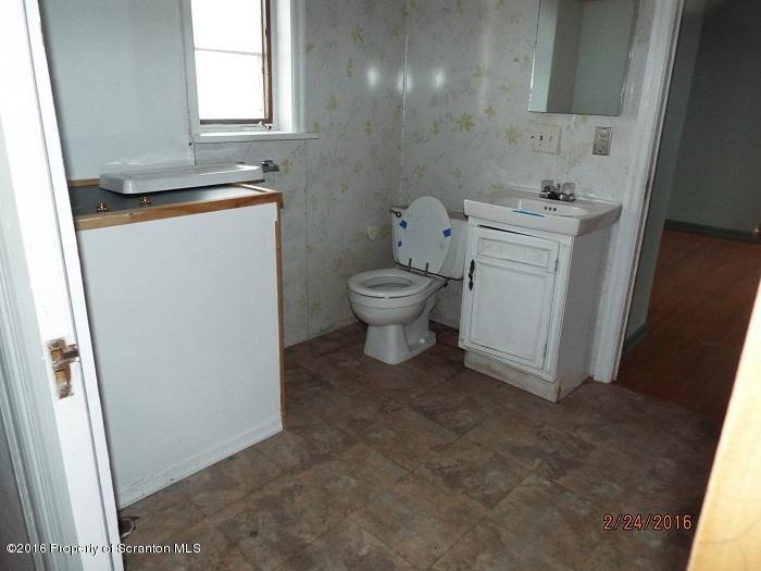 507 O'Hara Road Moscow, PA 18444 - Photo 10 of 13 a bathroom with a toilet sink and mirror