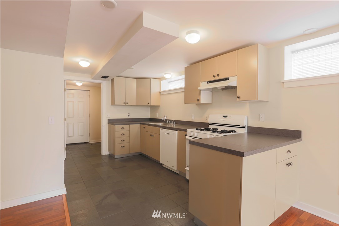1706 North 50th Street Seattle, WA 98103 - Photo 12 of 18 a kitchen with a stove top oven sink and cabinets