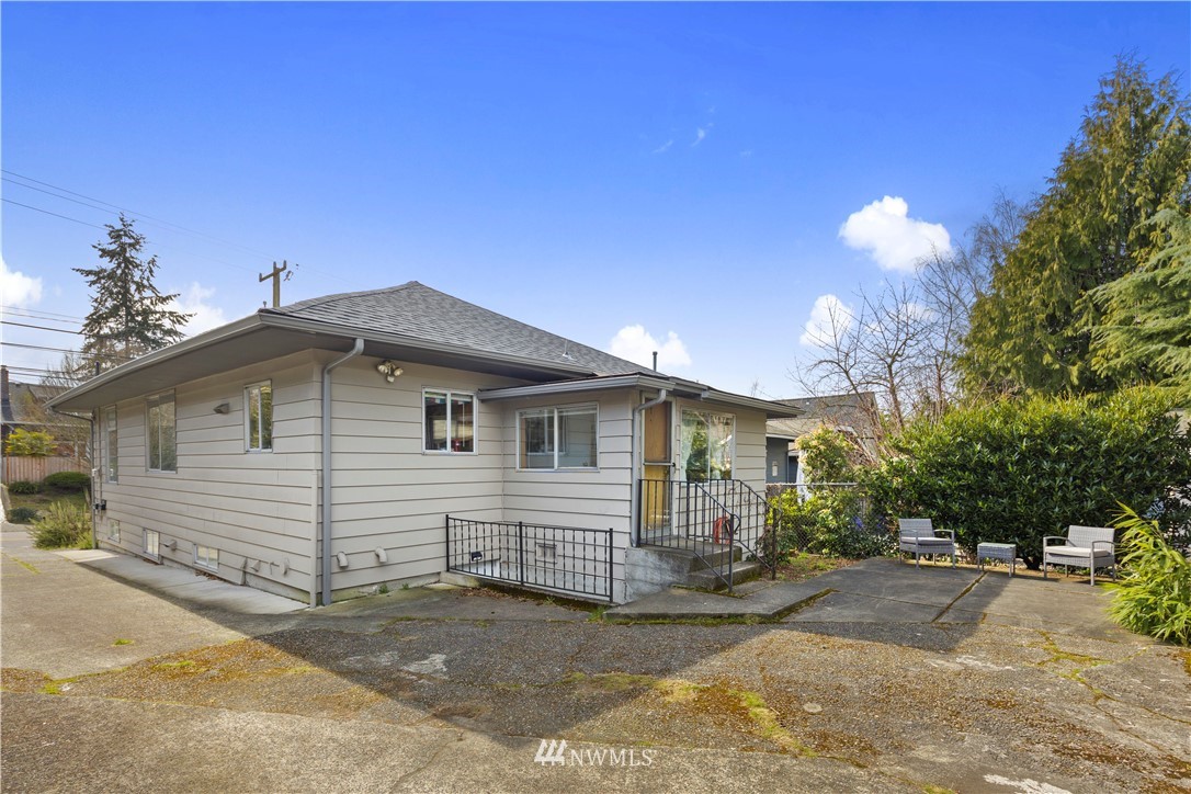 1706 North 50th Street Seattle, WA 98103 - Photo 17 of 18 a view of a house with a yard and potted plants