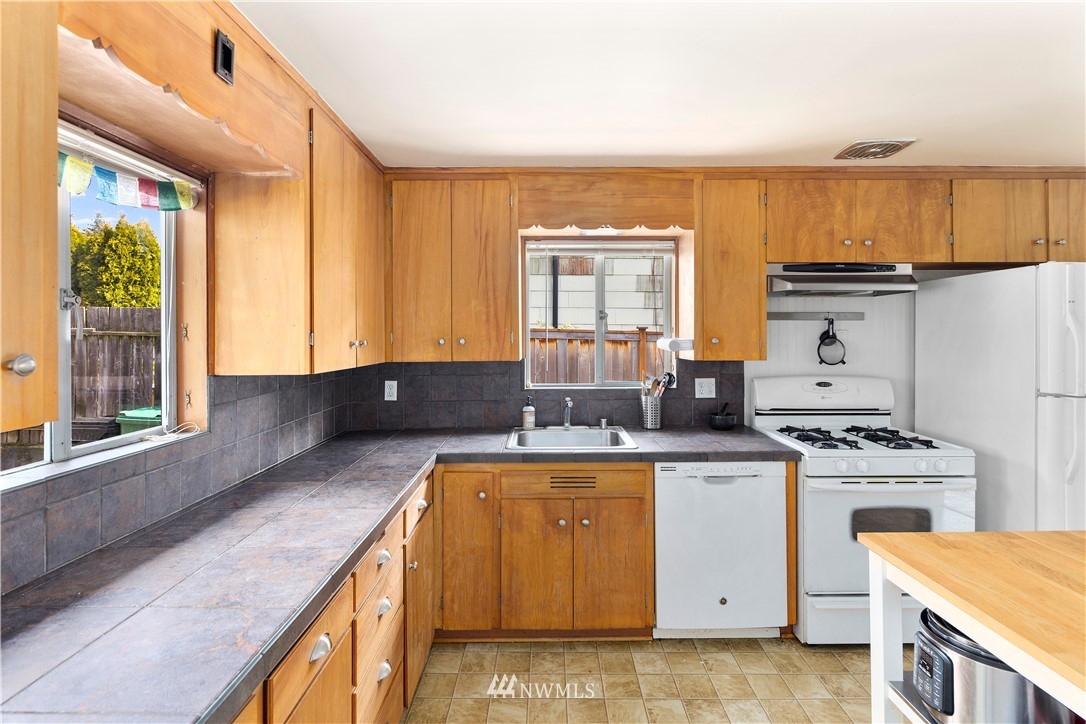 1706 North 50th Street Seattle, WA 98103 - Photo 3 of 18 a kitchen with a stove and a microwave
