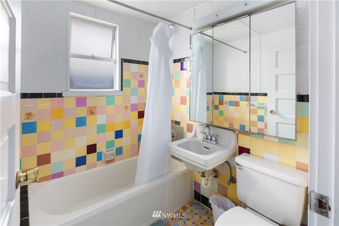 1706 North 50th Street Seattle, WA 98103 - Photo 8 of 18 a bathroom with a sink toilet and shower