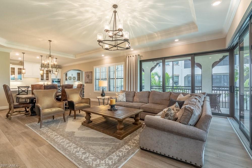 a living room with lots of furniture and a chandelier