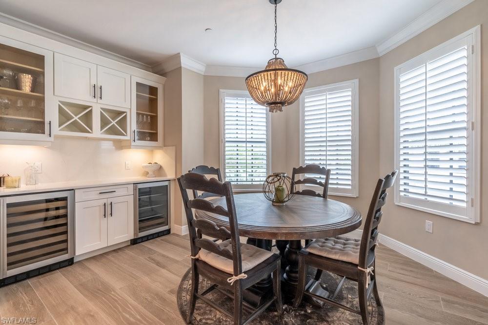 16375 Viansa Way, Unit 102 Naples, FL 34110 - Photo 12 of 40 a kitchen with a dining table and chairs