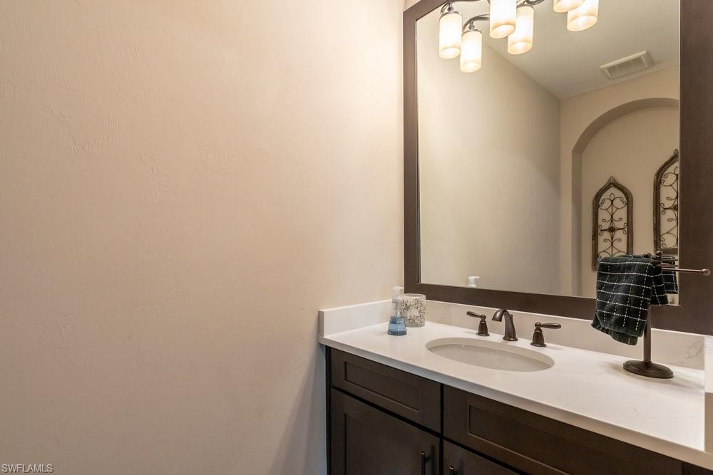 16375 Viansa Way, Unit 102 Naples, FL 34110 - Photo 13 of 40 a bathroom with a sink and a mirror