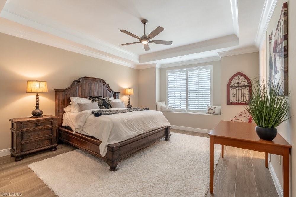 16375 Viansa Way, Unit 102 Naples, FL 34110 - Photo 15 of 40 a bed sitting in a spacious bedroom next to a window