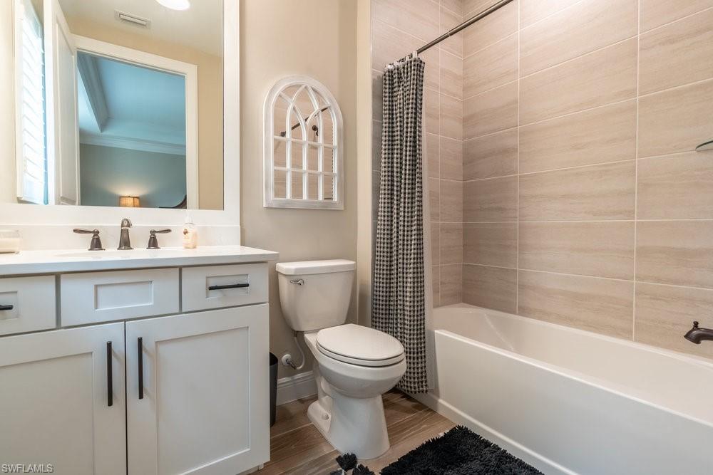 16375 Viansa Way, Unit 102 Naples, FL 34110 - Photo 17 of 40 a bathroom with a sink toilet and shower