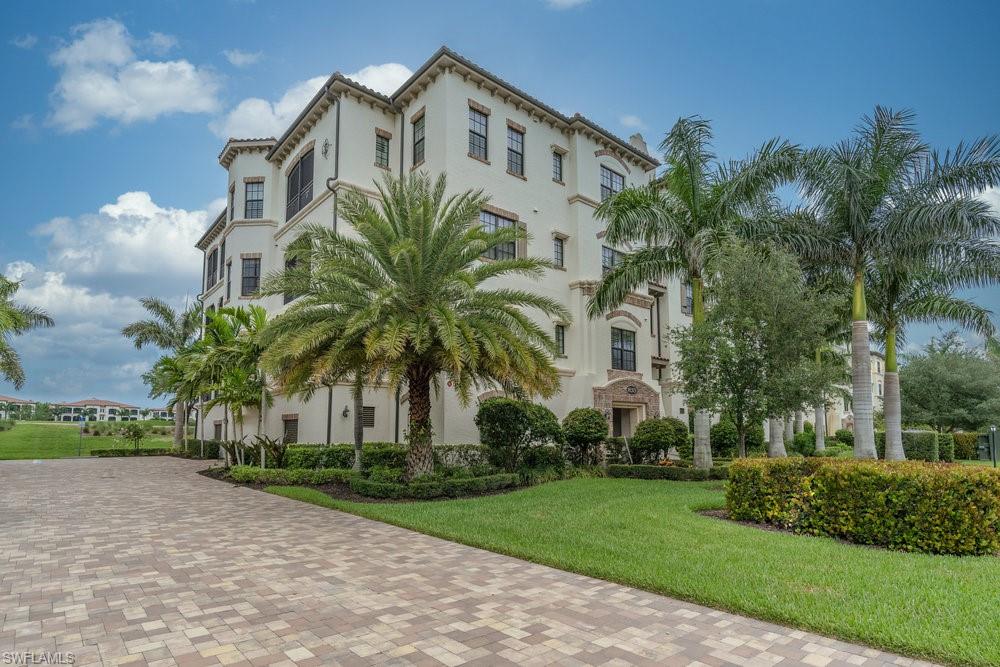 16375 Viansa Way, Unit 102 Naples, FL 34110 - Photo 2 of 40 a front view of multiple houses with yard