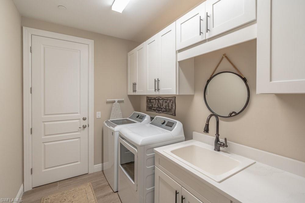 16375 Viansa Way, Unit 102 Naples, FL 34110 - Photo 26 of 40 a bathroom with a sink and a mirror