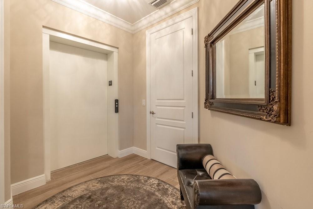 16375 Viansa Way, Unit 102 Naples, FL 34110 - Photo 3 of 40 a bedroom with a bed and a couch