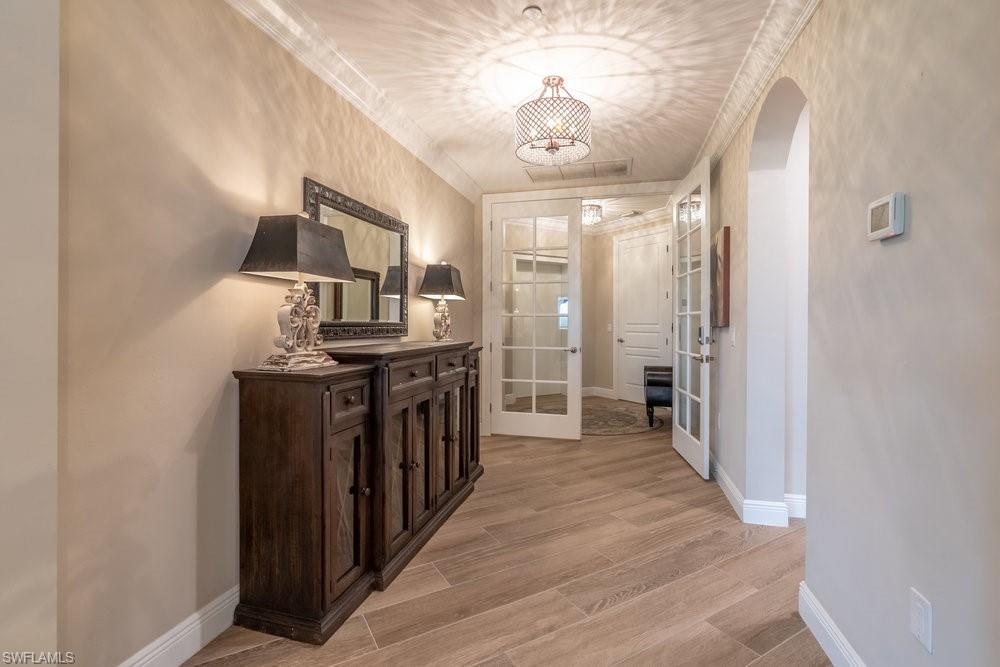 16375 Viansa Way, Unit 102 Naples, FL 34110 - Photo 4 of 40 a view of a hallway with wooden floor
