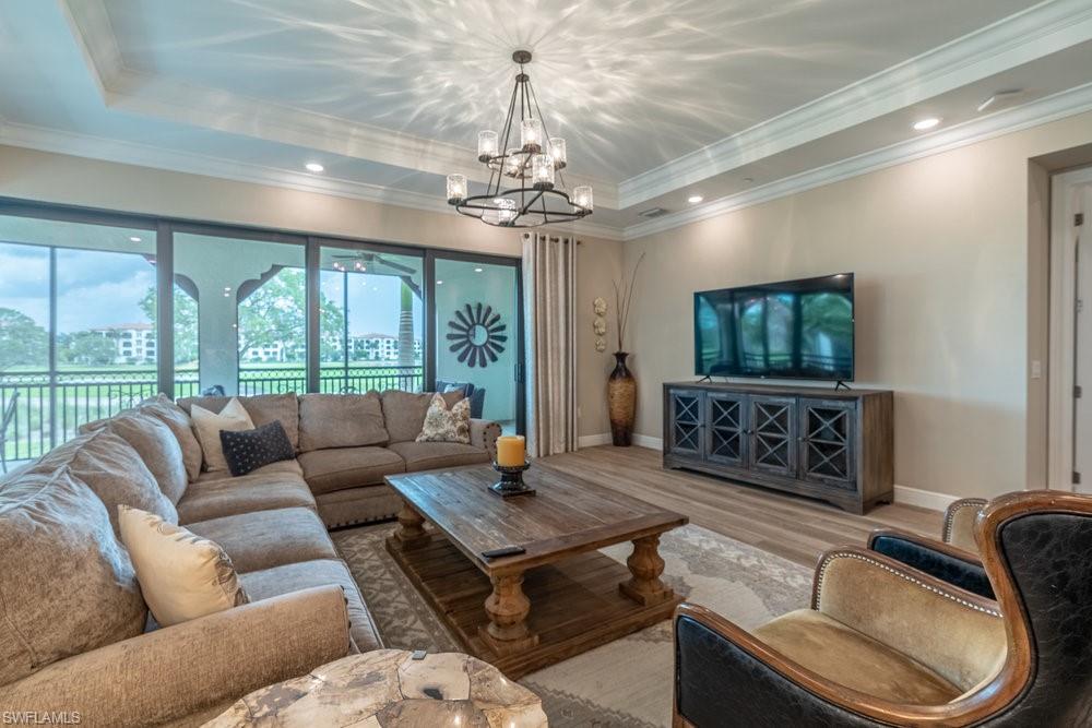 16375 Viansa Way, Unit 102 Naples, FL 34110 - Photo 8 of 40 a living room with furniture and a flat screen tv