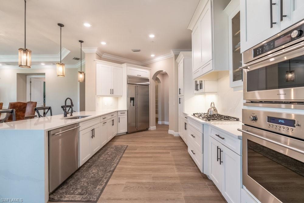 16375 Viansa Way, Unit 102 Naples, FL 34110 - Photo 10 of 40 a large kitchen with stainless steel appliances lots of counter space sink and cabinets