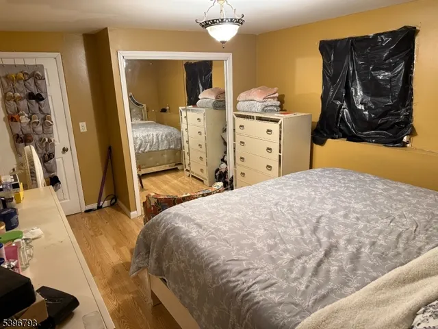 a bedroom with a bed and a mirror