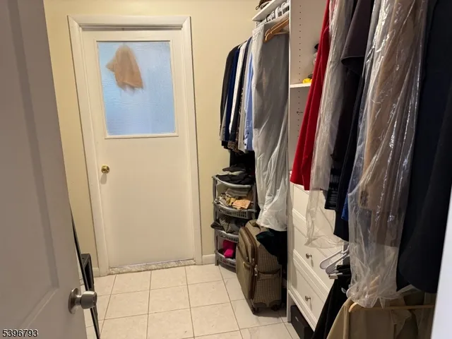 a view of walk in closet with clothes