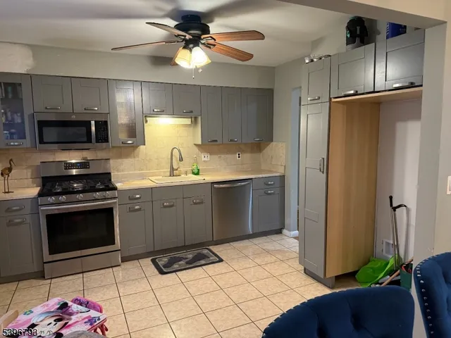 a kitchen with a sink appliances and cabinets