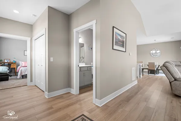 a view of a livingroom with wooden floor and furniture