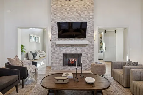 a dining room with furniture a chandelier and wooden floor